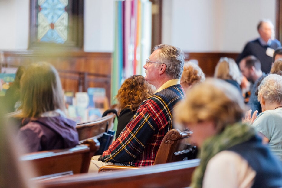 Man in a church listening during a worship service.