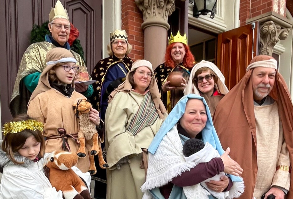 Carolers dressed up as a Living Creche manger
