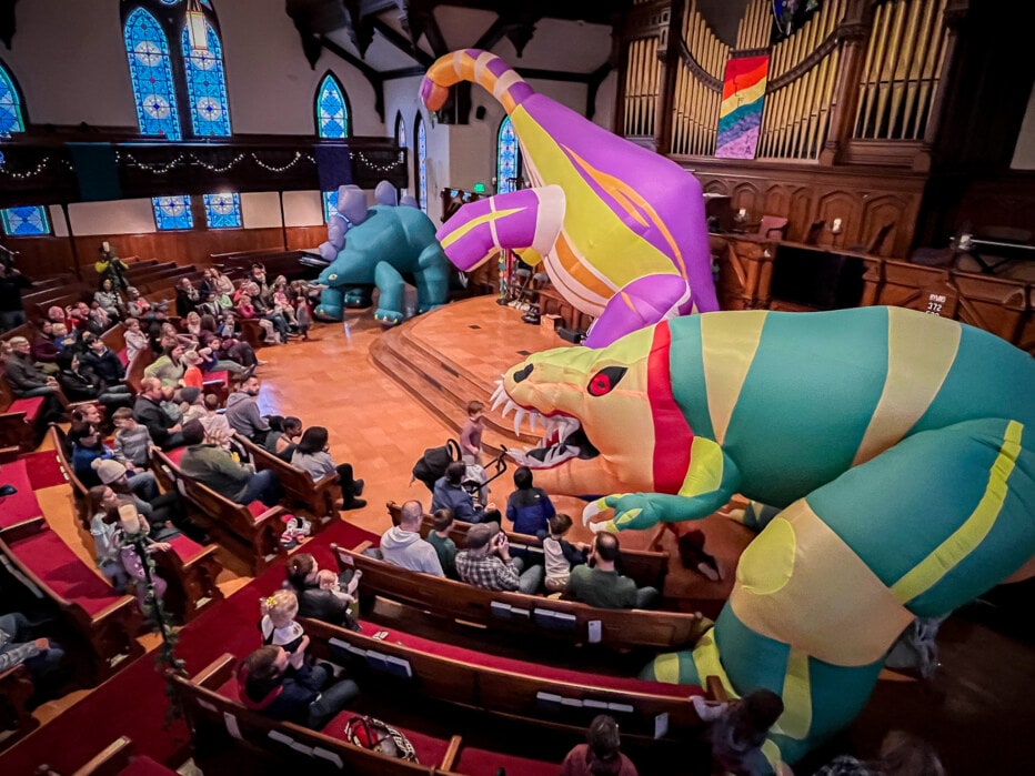 DinoMan inflatable dinosaurs in church sanctuary
